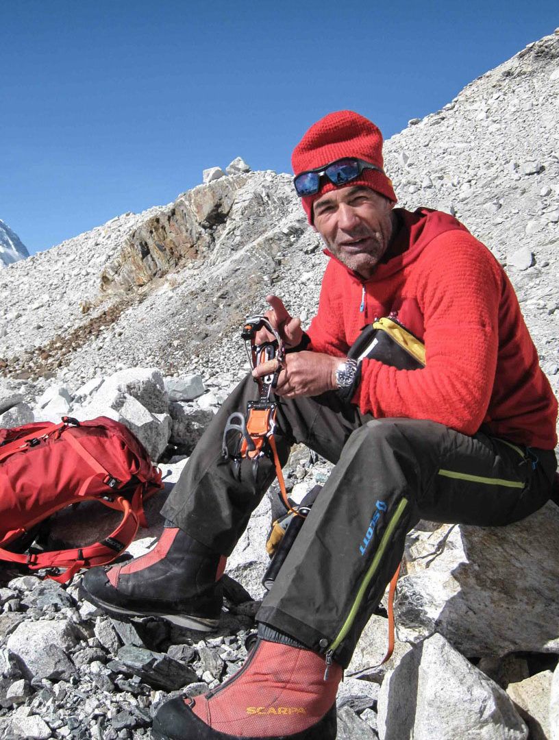 Mike horn sitting on a rock near Makalu Mike horn sitting on a rock near Makalu